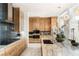 Modern kitchen with stainless steel appliances, stone countertops, and stylish pendant lighting at 13 Rockstream Dr, Henderson, NV 89012