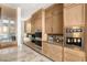 Gourmet kitchen with custom cabinetry, stainless steel appliances, and a built-in wine station at 13 Rockstream Dr, Henderson, NV 89012