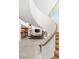 Open-concept living space with spiral staircase view of kitchen, fireplace, and sleek modern design at 13 Rockstream Dr, Henderson, NV 89012