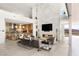 Spacious open-concept living area with modern fireplace, gourmet kitchen, and sliding glass doors to the outside at 13 Rockstream Dr, Henderson, NV 89012