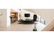 Open-concept living space with a fireplace, modern furnishings, and a view of the kitchen at 13 Rockstream Dr, Henderson, NV 89012