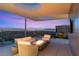 Cozy outdoor lounge with a fire pit and spectacular views of the cityscape at 13 Rockstream Dr, Henderson, NV 89012