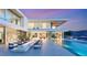 Modern home featuring an outdoor living space with a pool, fireplace, and lounge seating at 13 Rockstream Dr, Henderson, NV 89012