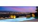 Beautiful infinity pool with lounge chairs overlooking the bright lights of the Las Vegas strip at 13 Rockstream Dr, Henderson, NV 89012