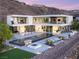A modern home featuring an inviting outdoor space with a pool, lounge area, and fire pit, perfect for entertaining at 13 Rockstream Dr, Henderson, NV 89012