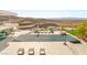 Expansive infinity pool with lounge seating offering breathtaking views of the surrounding mountain landscape at 13 Rockstream Dr, Henderson, NV 89012