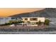 Modern two-story home with a pool, patio, and mountain views providing a private outdoor oasis at 13 Rockstream Dr, Henderson, NV 89012