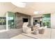 Elegant outdoor terrace with fireplace, cozy seating, and seamless indoor-outdoor living at 13 Rockstream Dr, Henderson, NV 89012