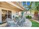 Relaxing covered patio with stylish wicker furniture and a glass-topped table, perfect for entertaining guests at 1353 Volturno Way, Henderson, NV 89052