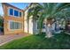 Beautiful backyard with lush green lawn and a large palm tree, perfect for outdoor relaxation at 1353 Volturno Way, Henderson, NV 89052