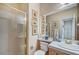 Bright bathroom featuring a shower, toilet, and a vanity sink with framed artwork at 1353 Volturno Way, Henderson, NV 89052