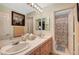 Bathroom featuring dual sinks, vanity, and separate door to the shower at 1353 Volturno Way, Henderson, NV 89052