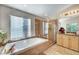 Bright bathroom featuring a separate shower and tub, with large windows bringing in natural light at 1353 Volturno Way, Henderson, NV 89052