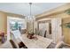 Elegant dining room featuring a chandelier and view into the living room at 1353 Volturno Way, Henderson, NV 89052