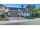 Spacious two-story home with a three car garage, complemented by a well-maintained lawn and mature trees at 1353 Volturno Way, Henderson, NV 89052