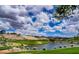 Scenic golf course view with lush green grass and a tranquil lake against a backdrop of upscale homes at 1353 Volturno Way, Henderson, NV 89052