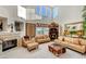 Cozy living room featuring a fireplace, comfortable furniture, and natural light at 1353 Volturno Way, Henderson, NV 89052