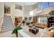 Spacious living room with high ceilings, fireplace, and large windows providing ample natural light at 1353 Volturno Way, Henderson, NV 89052