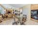 Open-concept living room with tile flooring, fireplace, and a table perfect for dining at 1353 Volturno Way, Henderson, NV 89052
