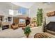 Bright living room featuring a fireplace, high ceilings, large windows, and comfortable seating at 1353 Volturno Way, Henderson, NV 89052