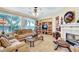 Comfortable living room featuring a fireplace, built-in shelves, and large window at 1353 Volturno Way, Henderson, NV 89052