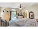 Comfortable primary bedroom featuring a ceiling fan, access to balcony, and closet at 1353 Volturno Way, Henderson, NV 89052