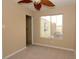 Cozy carpeted bedroom featuring a closet, window and ceiling fan at 1467 Hialeah Dr # C, Las Vegas, NV 89119