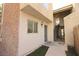 Exterior view of the building showing a brick wall and a door with exterior stairs to upper levels at 1467 Hialeah Dr # C, Las Vegas, NV 89119