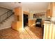 Functional kitchen features natural wood cabinets, a black refrigerator and a terracotta tiled floor at 1467 Hialeah Dr # C, Las Vegas, NV 89119