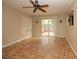 Bright living room with unique tile flooring, ceiling fan, and sliding glass door at 1467 Hialeah Dr # C, Las Vegas, NV 89119
