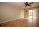 Bright living room with unique tile flooring, ceiling fan, and sliding glass door at 1467 Hialeah Dr # C, Las Vegas, NV 89119
