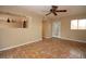 Bright living room with unique tile flooring, ceiling fan, and view into the kitchen at 1467 Hialeah Dr # C, Las Vegas, NV 89119