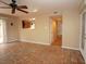 Bright living room with unique tile flooring, ceiling fan, and sliding glass door at 1467 Hialeah Dr # C, Las Vegas, NV 89119