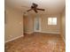 Bright living room with unique tile flooring, ceiling fan, and decorative front door at 1467 Hialeah Dr # C, Las Vegas, NV 89119