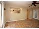 Bright living room with unique tile flooring, ceiling fan, and view into the kitchen at 1467 Hialeah Dr # C, Las Vegas, NV 89119