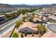 A beautiful home with a terra cotta tile roof alongside a busy street in a Primary-planned community at 1781 Cypress Lake Ct, Henderson, NV 89012