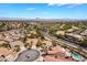 Panoramic aerial view of desert community featuring manicured lawns, lush landscaping, and scenic mountain views at 1781 Cypress Lake Ct, Henderson, NV 89012