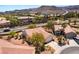 Aerial view of a desert community showcasing lush landscaping, mature trees and well-maintained homes at 1781 Cypress Lake Ct, Henderson, NV 89012