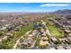 Stunning aerial view of a golf course community, showcasing lush green fairways, serene lakes, and luxurious homes at 1781 Cypress Lake Ct, Henderson, NV 89012