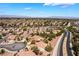 Expansive aerial view showcases a sprawling suburban community with well-maintained homes, lush landscaping, and scenic mountain views at 1781 Cypress Lake Ct, Henderson, NV 89012