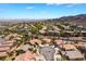Panoramic aerial view of desert community featuring manicured lawns, lush landscaping, and scenic mountain views at 1781 Cypress Lake Ct, Henderson, NV 89012