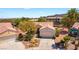 Aerial view of home featuring desert landscaping, a two-car garage, and a community at 1781 Cypress Lake Ct, Henderson, NV 89012