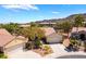 Aerial view of single-story home showcasing a two-car garage and desert landscaping at 1781 Cypress Lake Ct, Henderson, NV 89012