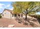 Backyard showing a covered patio area with large tree and neutral colored exterior at 1781 Cypress Lake Ct, Henderson, NV 89012