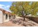 Backyard with covered patio and mature landscaping and neutral colored exterior at 1781 Cypress Lake Ct, Henderson, NV 89012