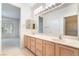 Bathroom features double sinks, large mirror, clerestory windows, and walk-in closet access at 1781 Cypress Lake Ct, Henderson, NV 89012