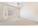 Spacious carpeted bedroom with bay window, ceiling fan, and neutral decor at 1781 Cypress Lake Ct, Henderson, NV 89012