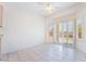 Bright dining room with tile floors, a ceiling fan, and a large window with shutter-style coverings at 1781 Cypress Lake Ct, Henderson, NV 89012