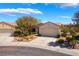 Inviting single-story home with a two-car garage, mature trees, and desert landscaping at 1781 Cypress Lake Ct, Henderson, NV 89012