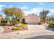 Charming single-story home with a xeriscaped front yard, two-car garage, and covered entry at 1781 Cypress Lake Ct, Henderson, NV 89012